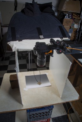 Camera extended with copy stand and tripod fitting over jewelry