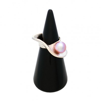 a mobius shaped ring with a pink pear shown on a black velvet cone in front of a white background