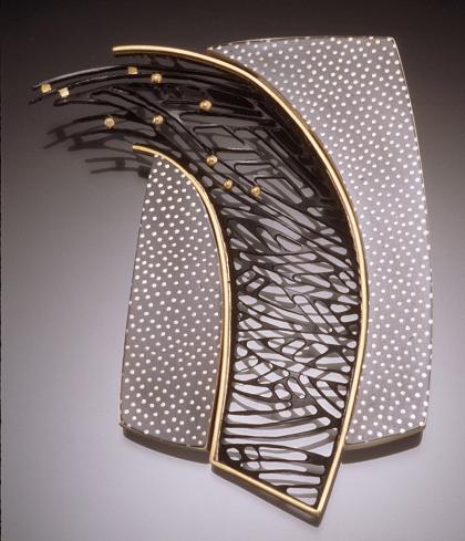 Brooch by artist Carol Webb. Breakthrough etched center swoop of silver with gold balls interspersed at the top 40%, gold eged and soldered to dotted metal