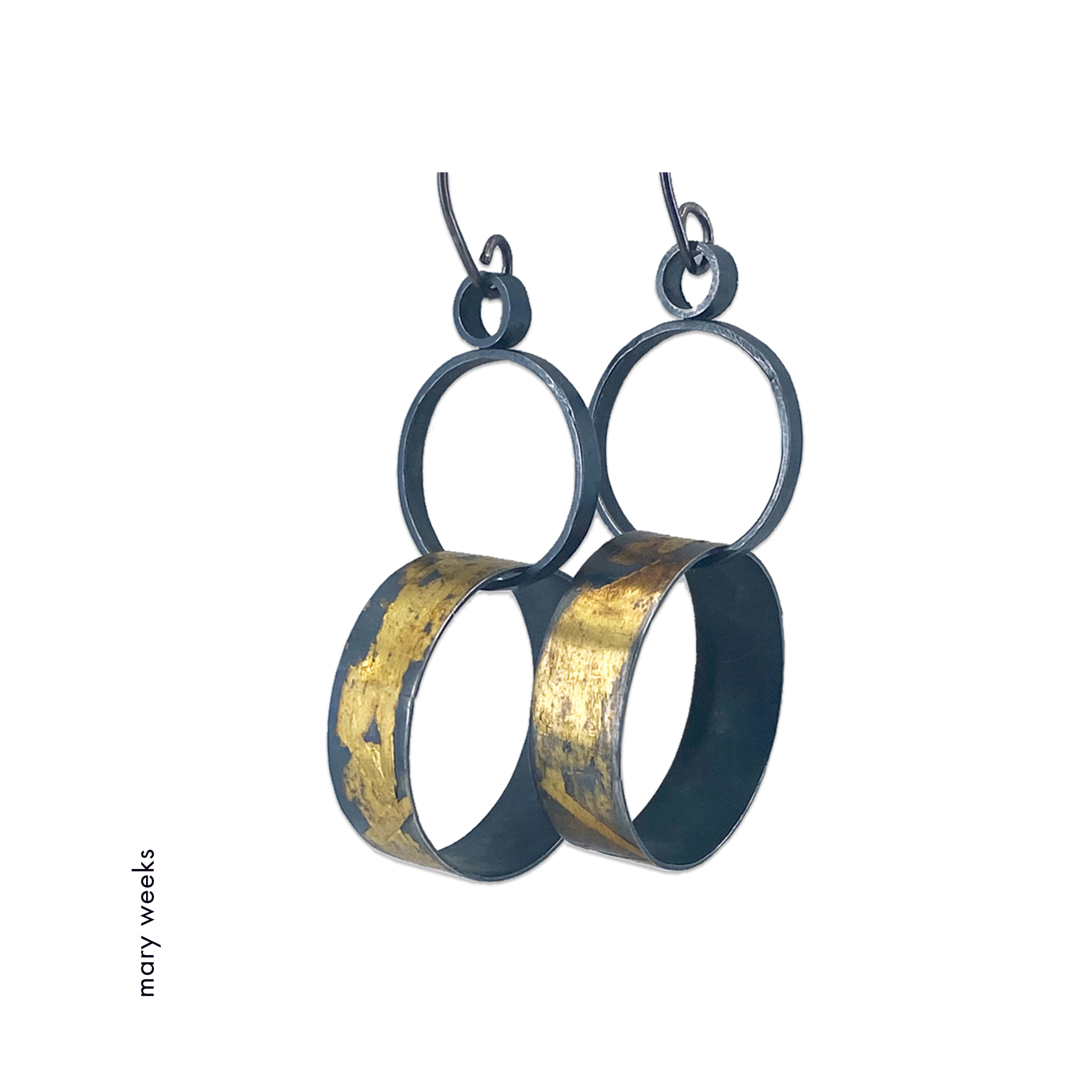 Mary Weeks made these oxidized sterling silver earrings made of two interlocking hoops; the bottom of each with Keum Boo applied gold.